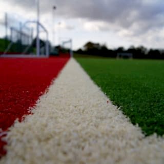 red turf, white lines, grass manufacturer, grass factory, synthetic, artificial, sports grass, sports turf production, sports turf manufacturing
